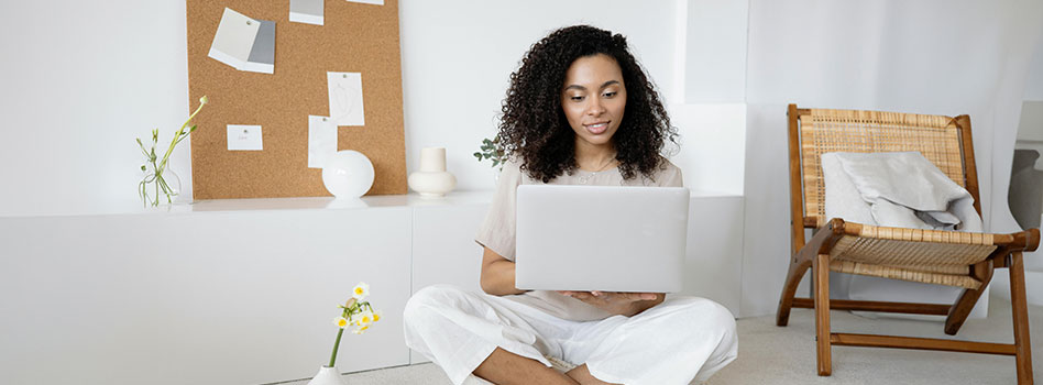 Girl sitting on the floor with her laptop computer