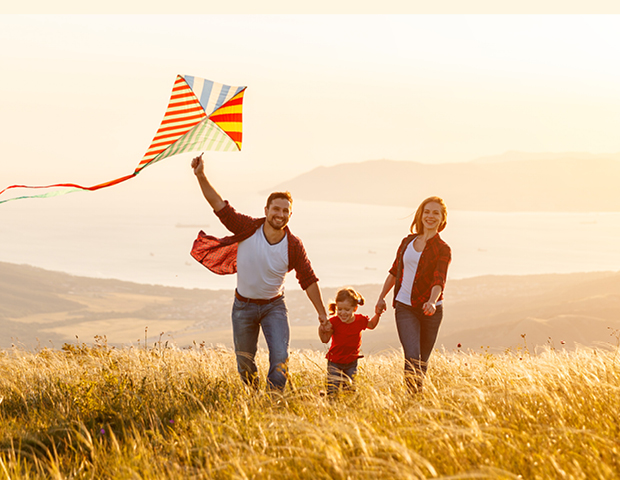 Mom, Dad, 2 kids flying a kite